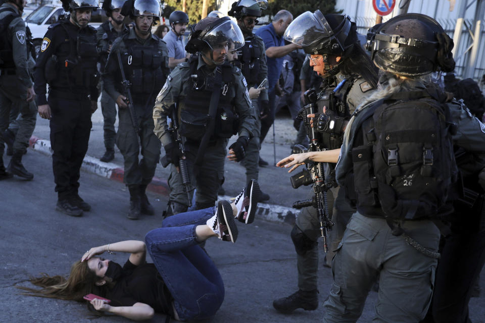 Israeli police scuffle with protesters in the Sheikh Jarrah neighborhood of east Jerusalem Saturday, May 15, 2021. The tensions began in east Jerusalem earlier this month, when Palestinians protested attempts by settlers to forcibly evict a number of Palestinian families from their homes. (AP Photo/Mahmoud Illean)