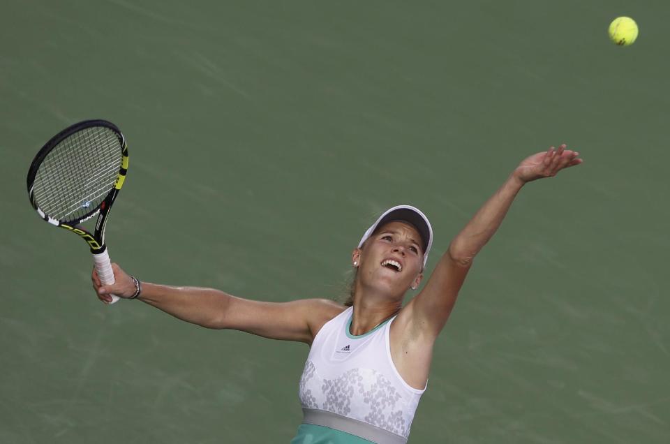 Caroline Wozniacki of Denmark serves the ball to Sabine Lisicki of Germany during the second round of Dubai Duty Free Tennis Championships in Dubai, United Arab Emirates, Tuesday, Feb. 18, 2014. (AP Photo/Kamran Jebreili)