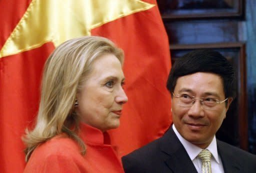 US Secretary of State Hillary Clinton (L) is greeted by Vietnam's Foreign Minister Pham Binh Minh at the Government Guest House in Hanoi. Clinton witnessed the signing of two deals between General Electric and Vietnam's biggest state-owned telecoms group Vietnamese National Power Transmission Corporation, and a private Vietnamese company