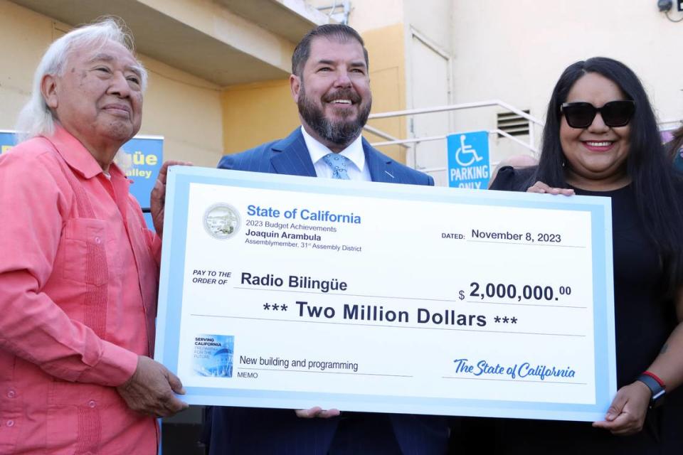 Radio Bilingüe founder/executive director Hugo Morales accepts a $2 million state allocation from Assemblymember Joaquín Arámbula and his district director, María Lemus, during a Nov. 8, 2023 ceremony at the radio station’s southeast Fresno facility.