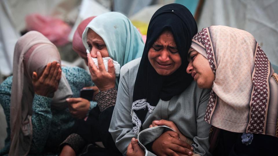 PHOTO: Palestinians mourn relatives, who were killed in an overnight Israeli airstrike on the Al-Maghazi refugee camp, during a mass funeral at the Al-Aqsa Hospital in Deir al-Balah in the central Gaza Strip on Dec. 25, 2023. (Mahmud Hams/AFP via Getty Images)