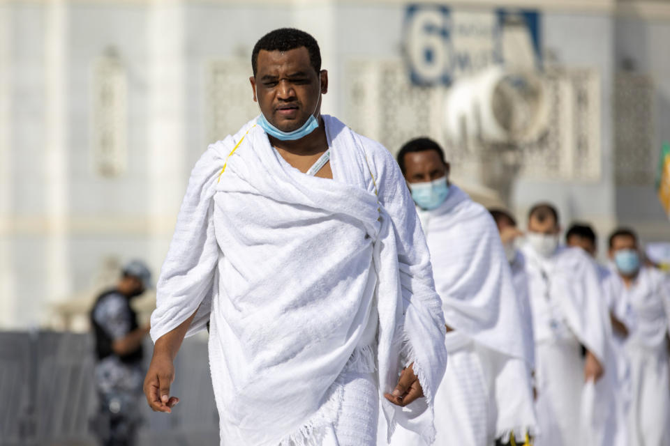 In this photo released by the Saudi Media Ministry, a limited numbers of pilgrims move several feet apart, circling the cube-shaped Kaaba in the first rituals of the hajj, as they keep social distancing to limit exposure and the potential transmission of the coronavirus, at the Grand Mosque in the Muslim holy city of Mecca, Saudi Arabia, Wednesday, July 29, 2020. The hajj, which started on Wednesday, is intended to bring about greater humility and unity among Muslims. (Saudi Media Ministry via AP)