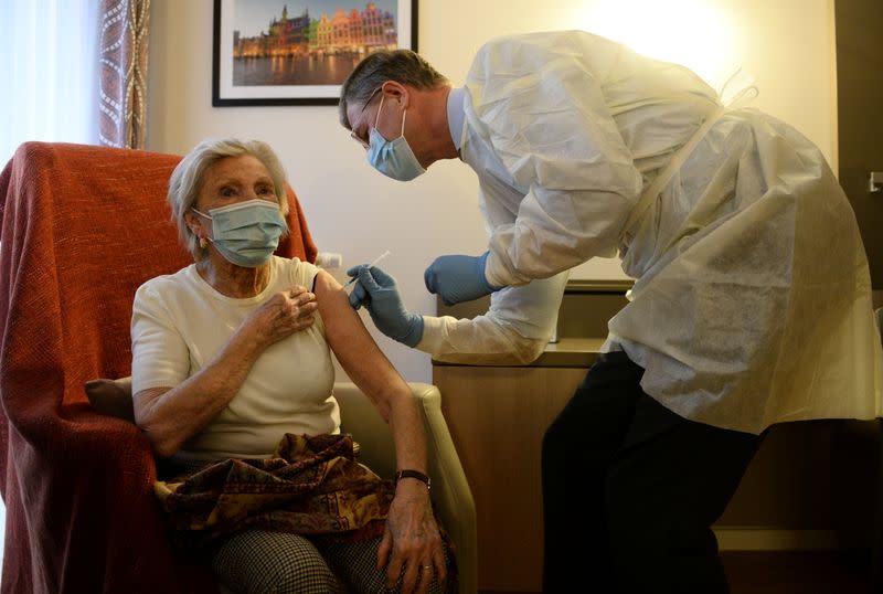 Lucie Vandamme receives a dose of the Pfizer-BioNTech COVID-19 vaccine at Prince Royal home care in Brussels