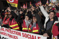 CGT Union protesters cheer at a march during a mass strike in Marseille, southern France, Tuesday, Dec. 10, 2019. French airport employees, teachers and other workers joined nationwide strikes Tuesday as unions cranked up pressure on the government to scrap upcoming changes to the country's national retirement system. (AP Photo/Daniel Cole)