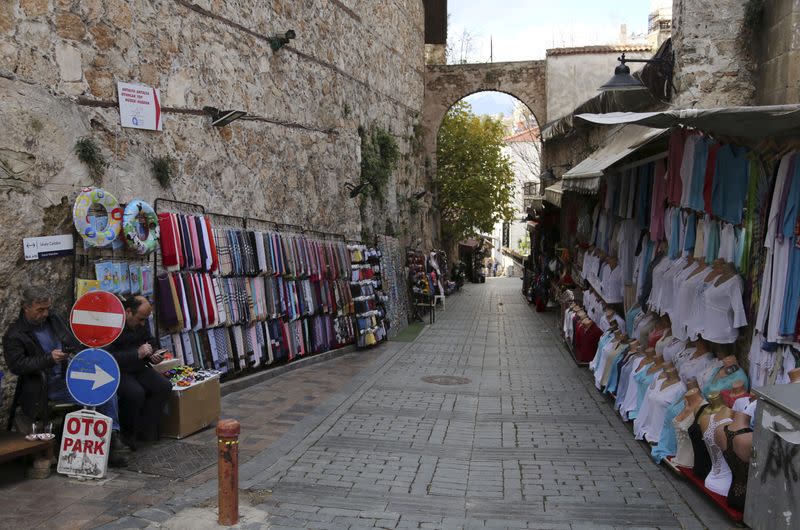 FILE PHOTO: Shop vendors wait for customers in the Mediterranean resort city of Antalya, a popular destination for German tourists, in Turkey