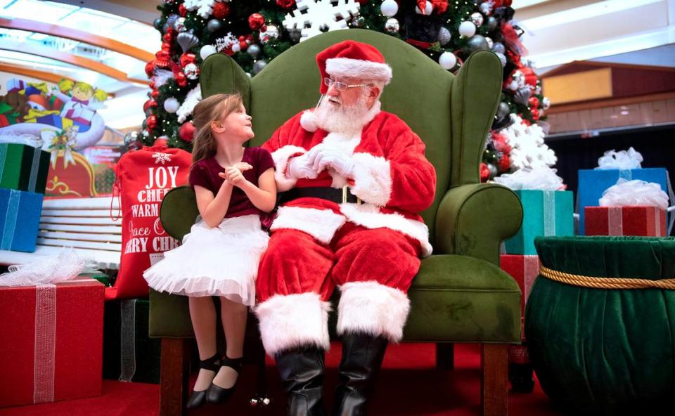 Zoey Kimball, 6, of Eatonville, talks with Santa at the South Hill Mall in Puyallup, Washington, on Wednesday, Nov. 24, 2021.