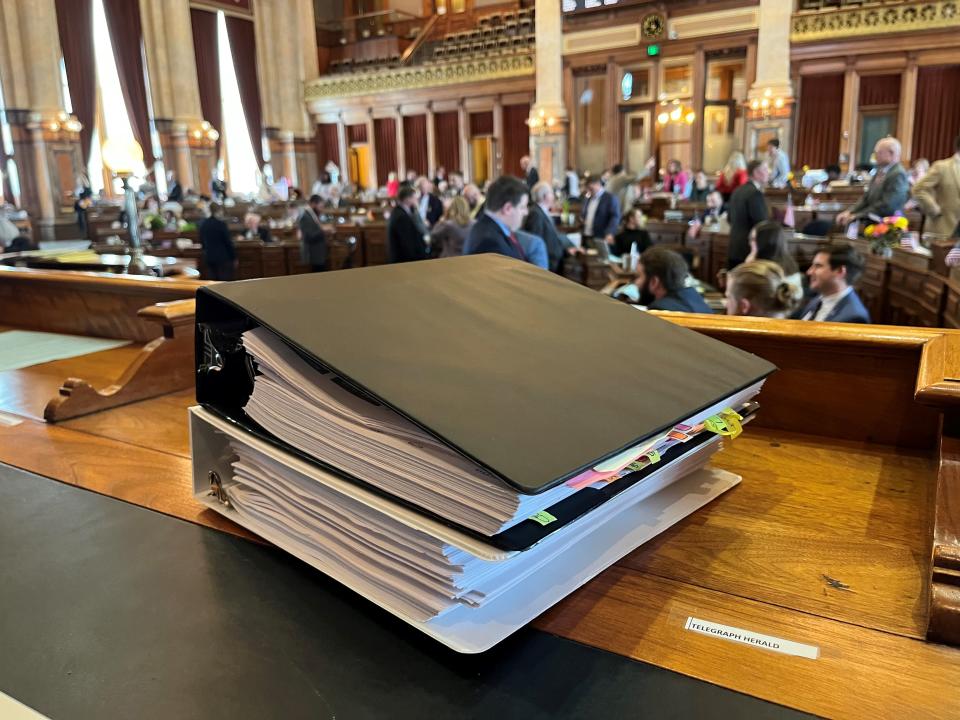 Gov. Kim Reynolds' bill to reorganize state government is pictured in the Iowa House on Wednesday, March 15, 2023. The 1,500-page bill fills two binders.