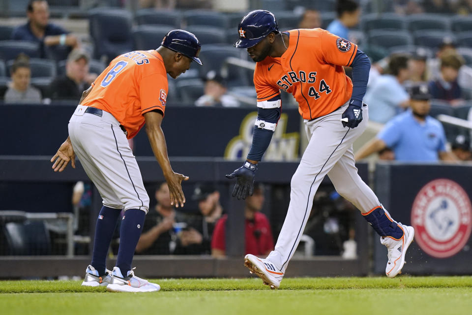 Houston Astros' Yordan Alvarez (44) celebrates with third base coach Gary Pettis as he runs the bases after hitting a three-run home run against the New York Yankees during the third inning of a baseball game Thursday, June 23, 2022, in New York. (AP Photo/Frank Franklin II)