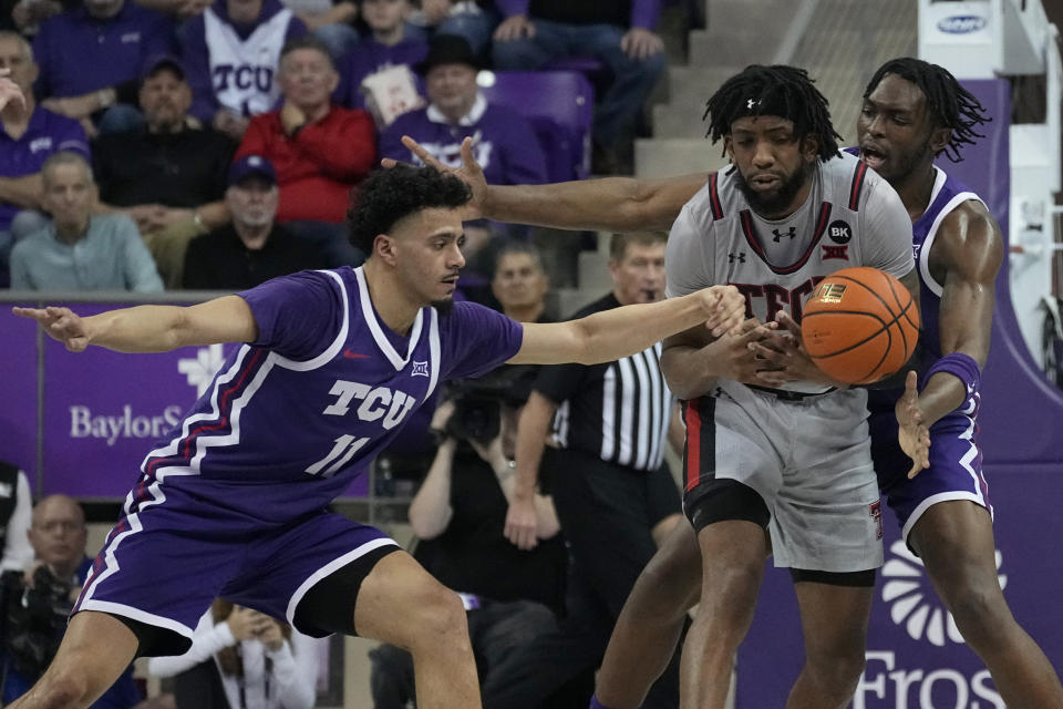 TCU guard Trevian Tennyson (11) and Ernest Udeh Jr., right, rear, combine to strip the ball away from Texas Tech forward Warren Washington (22) in the first half of an NCAA college basketball game in Fort Worth, Texas, Tuesday, Jan. 30, 2024. (AP Photo/Tony Gutierrez)