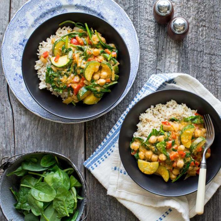 <p>To make this 20-minute vegan curry even faster, buy precut veggies from the salad bar at the grocery store. To make it a full, satisfying dinner, serve over cooked brown rice. When shopping for simmer sauce, look for one with 400 mg of sodium or less and check the ingredient list for cream or fish sauce if you want to keep this vegan. If you like a spicy kick, add a few dashes of your favorite hot sauce at the end. <a href="https://www.eatingwell.com/recipe/267876/vegan-coconut-chickpea-curry/" rel="nofollow noopener" target="_blank" data-ylk="slk:View Recipe" class="link ">View Recipe</a></p>