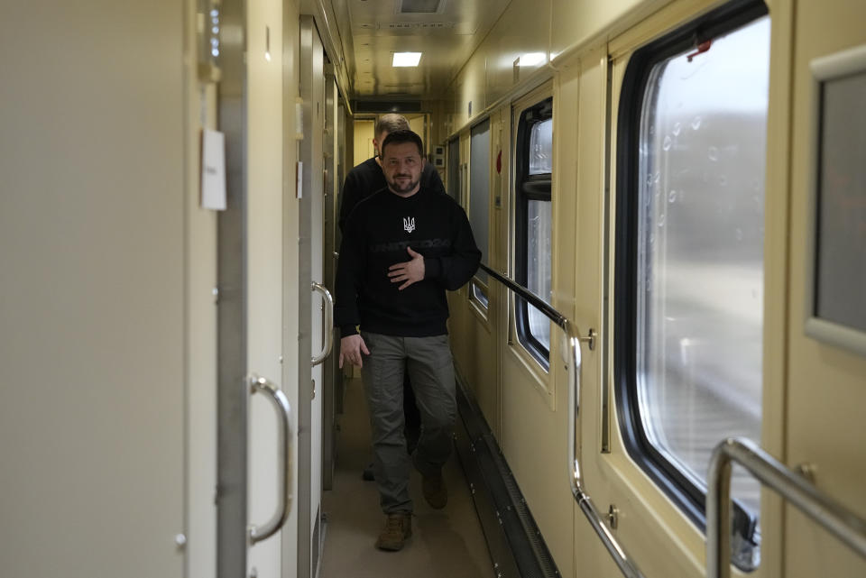 Ukrainian President Volodymyr Zelenskyy walks down a corridor as he arrives for an interview with The Associated Press on a train traveling from the Sumy region to Kyiv, Ukraine, Tuesday March 28, 2023. (AP Photo/Efrem Lukatsky)