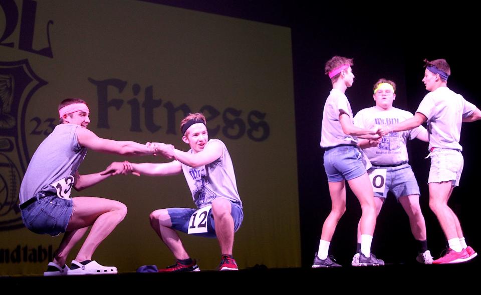 Cole Baker, left, and Isaac Bridges, center, dance during the fitness portion of the Mr. BNL event Friday, March 31, 2023.