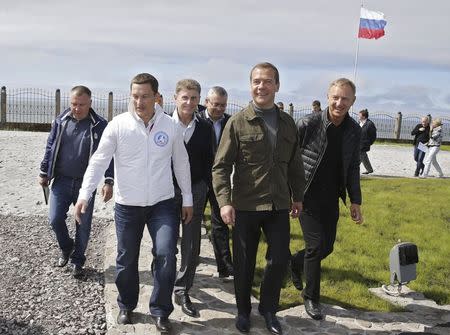 Russia's Prime Minister Dmitry Medvedev (2nd R, front), accompanied by Minister of Education and Science Dmitry Livanov (R) and other officials, attends the all-Russian youth educational forum "Iturup" in Kurilsk during his visit to Iturup Island, one of four islands known as the Southern Kurils in Russia and the Northern Territories in Japan, August 22, 2015. REUTERS/Dmitry Astakhov/RIA Novosti/Pool