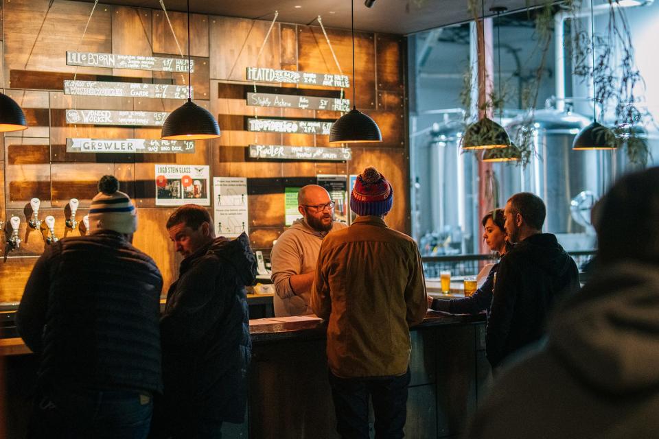 People gather at the taproom at Gathering Place Brewing