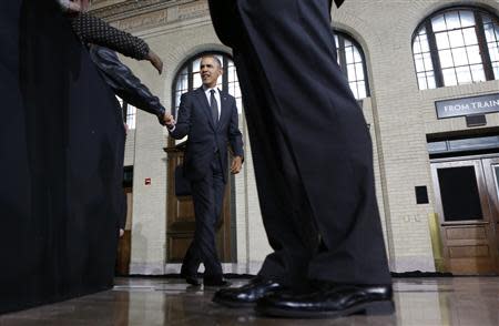 A Secret Service agent keeps watch as U.S. President Barack Obama shakes hands as he arrives to speak at Union Depot in St. Paul, Minnesota February 26, 2014. REUTERS/Kevin Lamarque