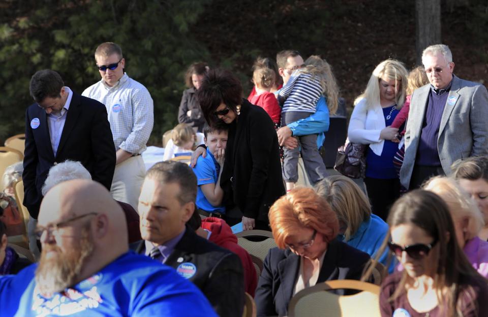 FILE - In this March 14, 2014 file photo, Attendees pray during a campaign event for Rev. Mark Harris, who is seeking a Republican U.S. Senate nomination in the upcoming North Carolina primary, in Raleigh, N.C., (AP Photo/Ted Richardson)