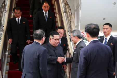 Singapore's Foreign Minister Vivian Balakrishnan welcomes North Korean leader Kim Jong Un on his arrival in Singapore, June 10, 2018 in this picture obtained from social media. SINGAPORE'S MINISTRY OF COMMUNICATIONS AND INFORMATION/via REUTERS