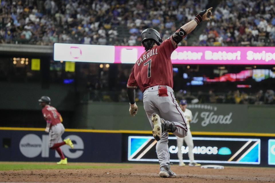 Arizona Diamondbacks' Corbin Carroll celebrates hiis two-run home run during the third inning of a Game 1 of their National League wildcard baseball game against the Milwaukee Brewers Tuesday, Oct. 3, 2023, in Milwaukee. (AP Photo/Morry Gash)