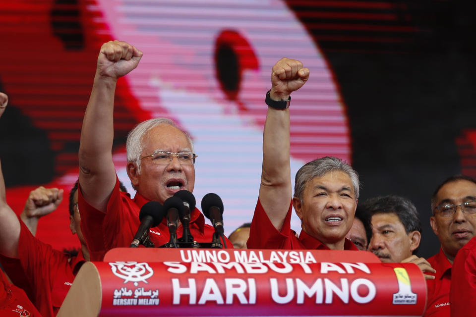 FILE - In this May 11, 2017, file photo, then Malaysian Prime Minister and President of Malaysia's ruling party United Malays National Organization's (UMNO) Najib Razak, left, and Deputy Prime Minister Ahmad Zahid Hamidi chant slogans during a celebration of party's 71st anniversary in Kuala Lumpur, Malaysia. After years of insisting on his innocence, Najib learns his fate this week in his first corruption trial linked to one of the world’s biggest financial scandals - a verdict widely seen as a test for the rule of law five months after a new government took power. July 28, 2020's ruling is being closely watched amid a stunning reversal of fortune for Najib’s Malay party, which returned to office as a key player in the new ruling alliance. (AP Photo/Vincent Thian, File)