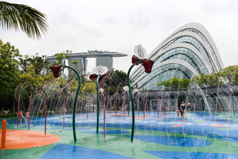 Children and elders enjoy a water fountain playground at the Gardens by the Bay in Singapore on April 2, 2019. (Photo: ROSLAN RAHMAN/AFP via Getty Images)