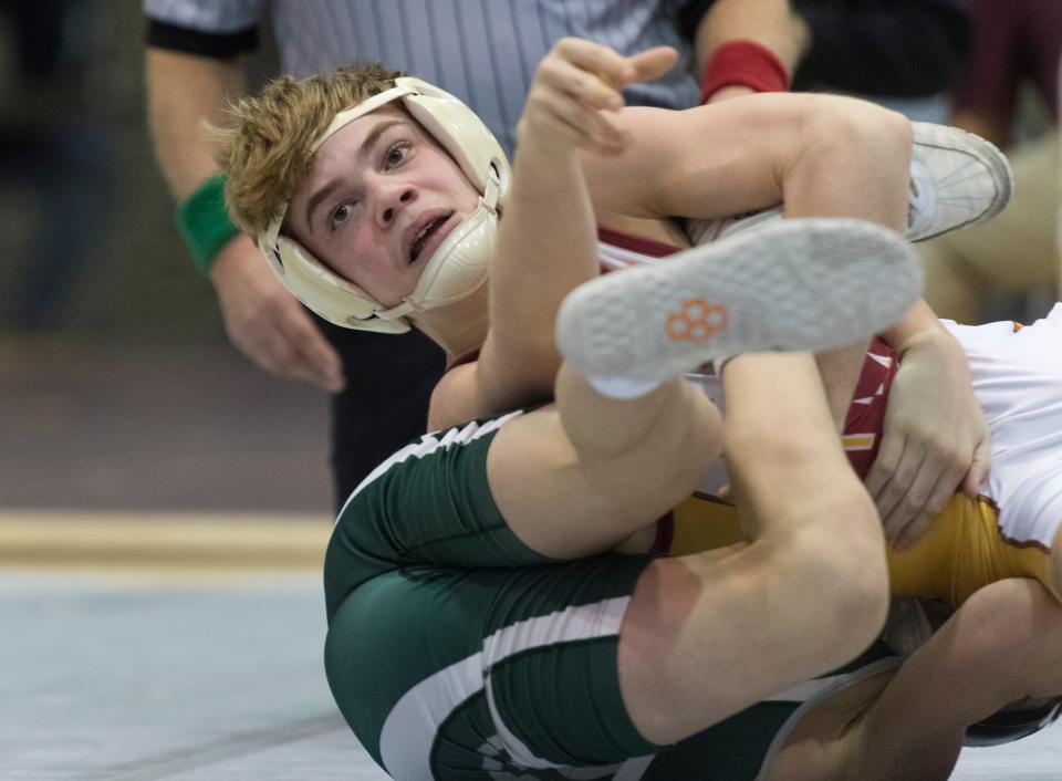 Isaiah Schaefer of Evansville Mater Dei, top, and Ty Henderson of Vincennes Lincoln, bottom, compete in the 106-pound championship match of the IHSAA 2022 Wrestling Sectional tournament at Central High School in Evansville, Ind., Saturday afternoon, Jan. 29, 2022.