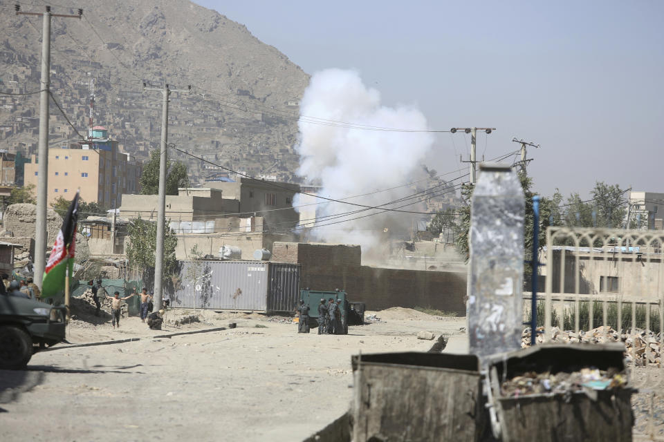 Smoke rises from a house where attackers are hiding in Kabul, Afghanistan, Tuesday, Aug. 21, 2018. The Taliban fired rockets toward the presidential palace in Kabul Tuesday as President Ashraf Ghani was giving his holiday message for the Muslim celebrations of Eid al-Adha, said police official Jan Agha. (AP Photo/Rahmat Gul)