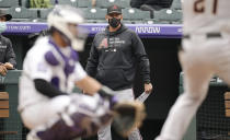 Arizona Diamondbacks manager Torey Lovullo, rear, looks on in the ninth inning of a baseball game against the Colorado Rockies Saturday, May 22, 2021, in Denver. The Rockies won 7-6. (AP Photo/David Zalubowski)