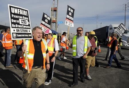 President of the International Brotherhood of Teamsters labour union James P. Hoffa walks a picket line before a news conference regarding truck drivers striking against what they say are misclassification of workers at the Ports of Long Beach and Los Angeles in Long Beach, California October 27, 2015. REUTERS/Bob Riha Jr.