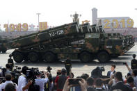 Military vehicles roll down during a parade to commemorate the 70th anniversary of the founding of Communist China in Beijing, Tuesday, Oct. 1, 2019. (AP Photo/Ng Han Guan)