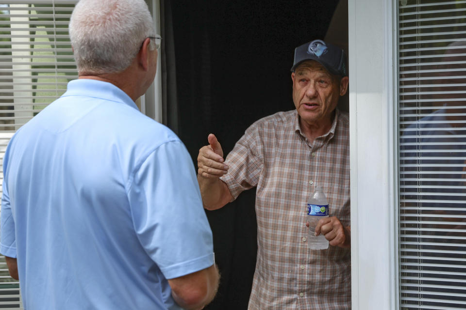 Glenn Cook, a Republican campaigning door-to-door for a seat in the Georgia state House, speaks with Skip White, right, in Kingsland, Ga., Tuesday, June 11, 2024. (AP Photo/Gary McCullough)