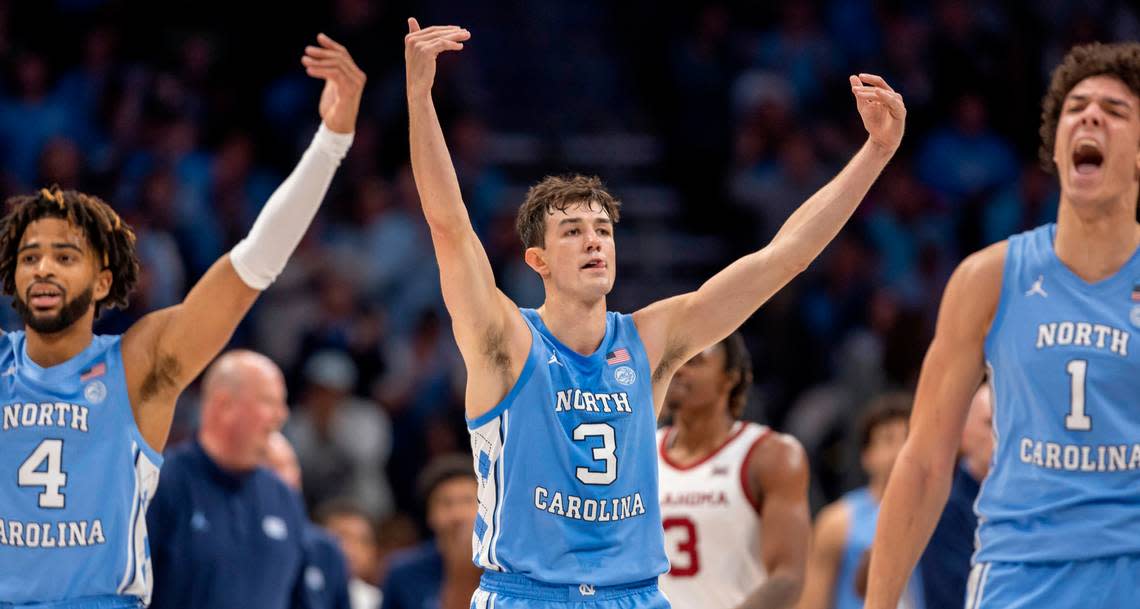 North Carolina’s R.J. Davis (4), Cormac Ryan (3) and Zayden High (1) work the crowd as the Tar Heels open a 57-43 lead over Oklahoma in the second half on Wednesday, December 20, 2023 at the Spectrum Center in Charlotte, N.C. The Tar Heels defeated the Sooners 81-69.