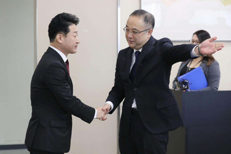 Lee Ho-hyeon, left, director-general for International Trade Policy at South Korea's Trade, Industry and Energy Ministry, is shown the way by Yoichi Iida, director-general of Japan's Trade Control Department before a director-general level meeting at the trade ministry in Tokyo Monday, Dec. 16, 2019. Senior officials from Japan and South Korea were holding talks Monday on high-tech exports for the first time since Tokyo tightened controls on South Korean semiconductor parts earlier this year. (Kyodo News via AP)