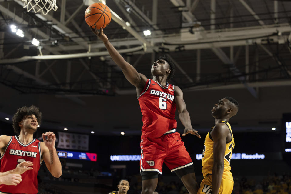 Dayton's Enoch Cheeks (6) shoots past Virginia Commonwealth's Joe Bamisile (22) during the first half of an NCAA college basketball game Friday, Feb. 9, 2024, in Richmond, Va. (AP Photo/Mike Kropf)