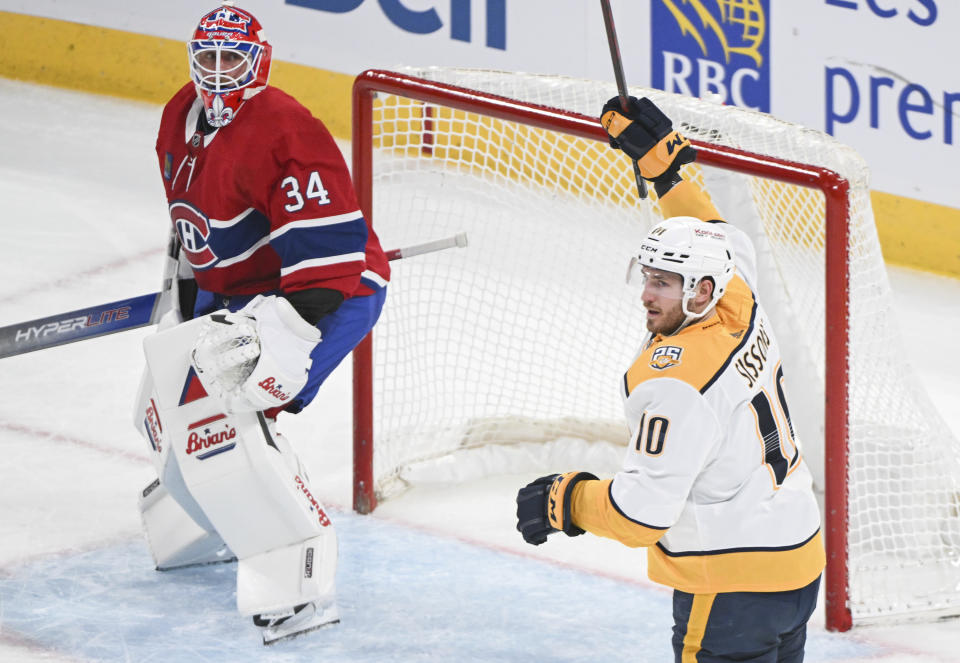 Nashville Predators' Colton Sissons (10) celebrates after scoring against Montreal Canadiens goaltender Jake Allen, left, during first-period NHL hockey game action in Montreal, Sunday, Dec. 10, 2023. (Graham Hughes/The Canadian Press via AP)