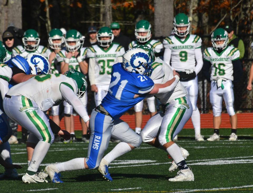 Kennebunk’s Moose Keys (21) tackles Massabesic’s Caleb Waters during Saturday’s Class B South championship in Kennebunk, Maine.