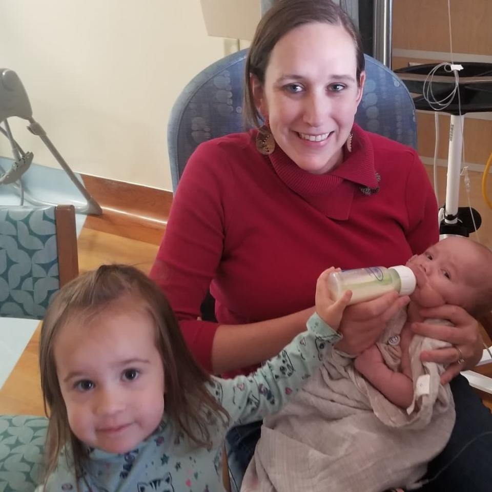 Mom Tiffany Nelsen gets help with feeding Benjamin from sister Marjorie at Shands.