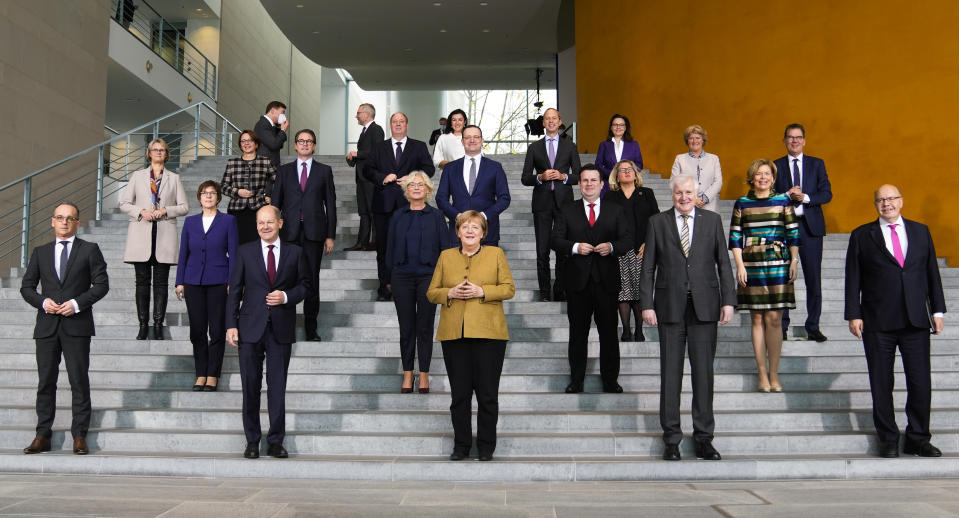 German Chancellor Angela Merkel, center, poses with her government after the cabinet meeting at the chancellery in Berlin, Germany, Wednesday, Nov. 24, 2021. Due to the schedule of coalition talks for a new German government it is probably her last cabinet session as German Chancellor.(AP Photo/Markus Schreiber, Pool)