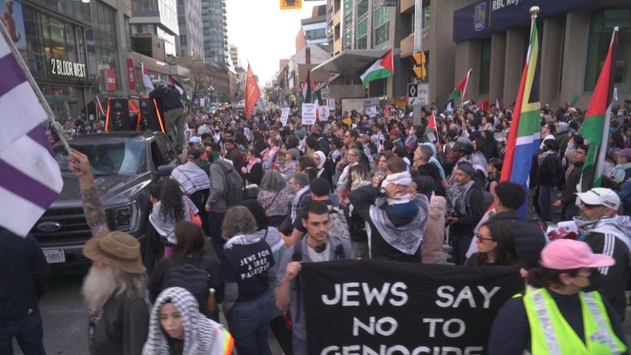 Pro-Palestinian demonstrators march in downtown Toronto on Tuesday. (CBC - image credit)
