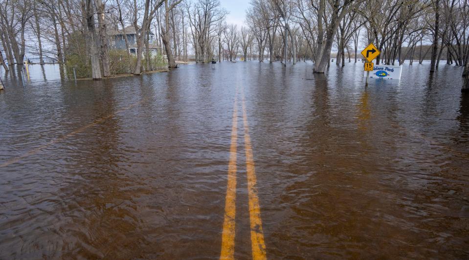 A road along the Mississippi River in the Town of Campbell, just outside La Crosse, is taken over by floodwaters April 27. Communities along the Upper Mississippi River are scrambling as the river swelled to near-record levels, forcing some to evacuate while others stacked sandbag walls and closed off flood-prone areas.