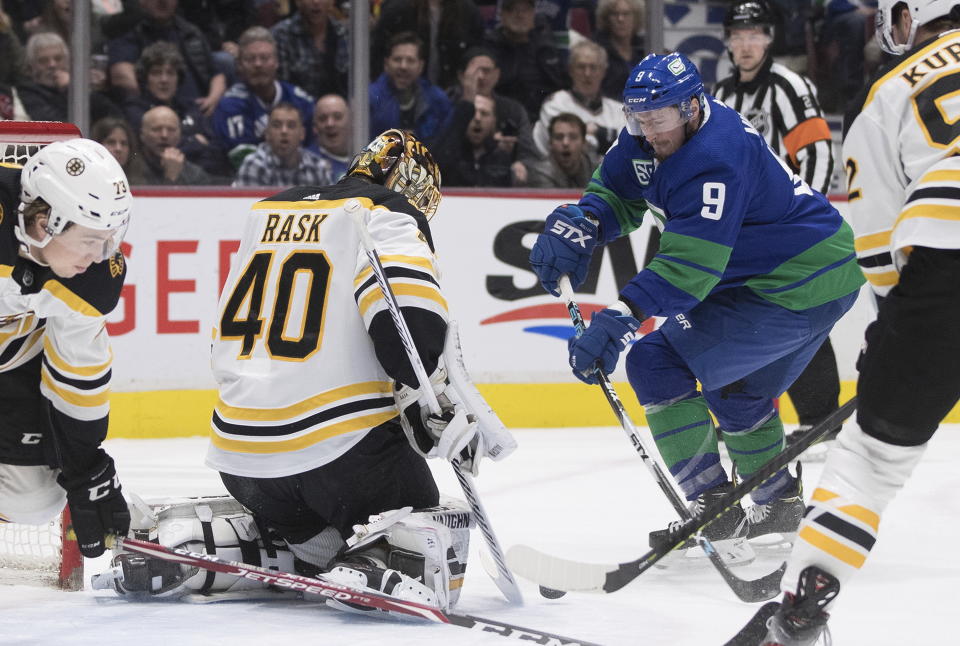 Boston Bruins goalie Tuukka Rask (40), of Finland, stops Vancouver Canucks' J.T. Miller (9) during the first period of an NHL hockey game Saturday, Feb. 22, 2020, in Vancouver, British Columbia. (Darryl Dyck/The Canadian Press via AP)