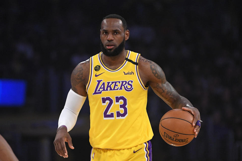 Los Angeles Lakers forward LeBron James dribbles during the first half of an NBA basketball game against the Philadelphia 76ers Tuesday, March 3, 2020, in Los Angeles. (AP Photo/Mark J. Terrill)