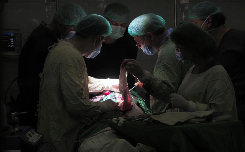 Doctors perform surgery in a basement of a hospital during shelling by Azerbaijan's artillery in Stepanakert, the separatist region of Nagorno-Karabakh, Wednesday, Oct. 28, 2020. Nagorno-Karabakh officials said Azerbaijani forces hit Stepanakert, the region's capital, and the nearby town of Shushi with the Smerch long-range multiple rocket systems, killing one civilian and wounding two more. (AP Photo)