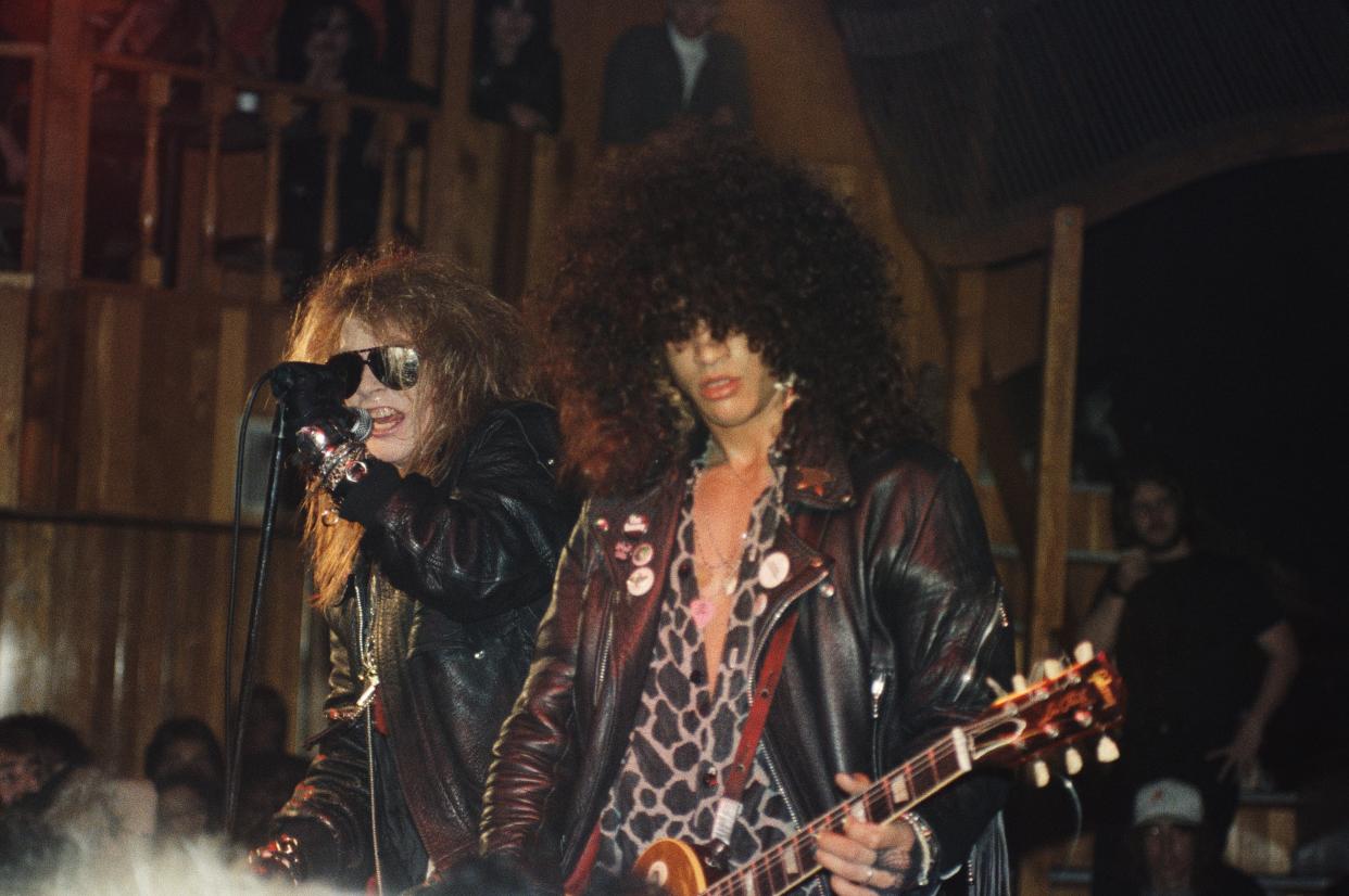 Axl Rose and Slash of Guns N' Roses perform at the Troubadour on the night that Tom Zutaut of Geffen Records, who would later sign them to a record deal, was in attendance. (Photo: Marc S. Canter/Michael Ochs Archives/Getty Images)