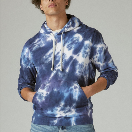 man in blue and white tie-dye hoodie with hands in pockets