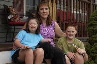 Jennifer Osgood, center, poses with her children Lily, 7, left, and Noah, 12, right, at their home in Fairfax, Vt., on Tuesday, July 20, 2021. The Osgood children will continued to be homeschool this upcoming school year. As the pandemic took hold across the United States in the spring of 2020, it brought disruption and anxiety to most families. Yet some parents are grateful for one consequence: they are now opting to homeschool their children even as schools plan to resume in-person classes. (AP Photo/Charles Krupa)