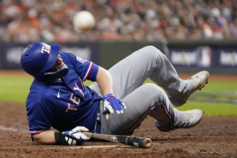 Texas Rangers' Corey Seager reacts after being hit by a pitch with bases loaded during the ninth inning of Game 6 of the baseball AL Championship Series against the Houston Astros Sunday, Oct. 22, 2023, in Houston. (AP Photo/Godofredo A. Vásquez)