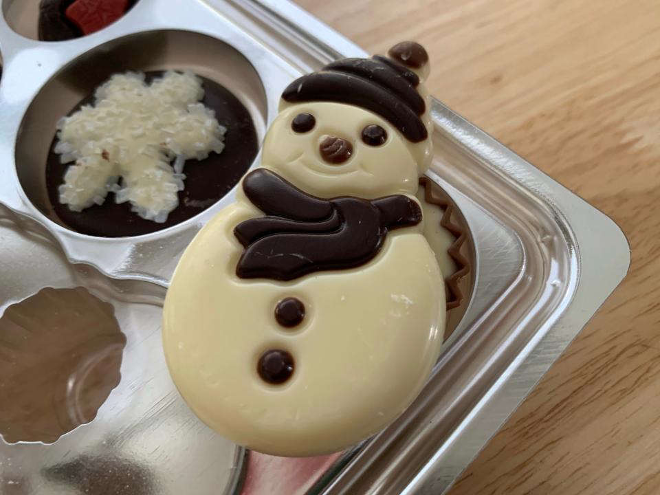 close up on trader joes snowman chocolate on plastic mold