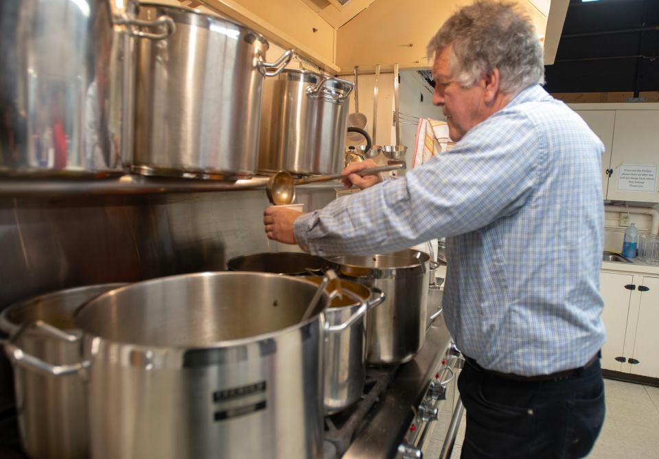 Mike Pottey ladles out cups of soup, getting ready for the noontime rush at the First Church of Sandwich's weekly soup luncheon, offering take out or sit down meals every Wednesday in the winter.