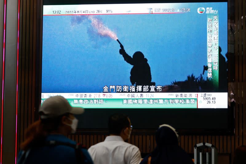 A TV screen shows that China's People's Liberation Army has begun military exercises including live firing on the waters and in the airspace surrounding the island of Taiwan, in Hong Kong