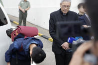 Chan Tong-kai, left, bows after talking to the media as he is released from prison in Hong Kong Wednesday, Oct. 23, 2019. Chan, who's wanted for killing his girlfriend last year on the self-ruled island, had asked the Hong Kong government for help turning himself in to Taiwan after his sentence for money laundering offenses ends on Wednesday. (AP Photo/Mark Schiefelbein)